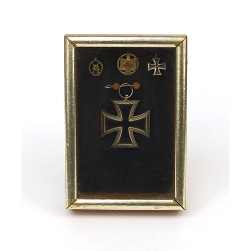 356 - German Military interest iron cross, two pendants and stick pin, all housed in a glazed case