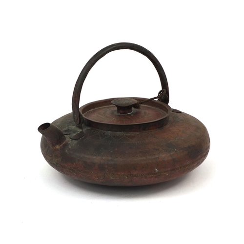 559 - Chinese copper kettle with swinging handle and planished decoration, the body 22cm in diameter