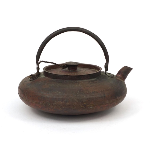 559 - Chinese copper kettle with swinging handle and planished decoration, the body 22cm in diameter