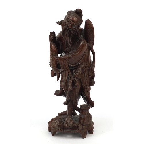 543 - Chinese hardwood root carving of a fisherman holding a fish, 30cm high