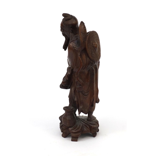 543 - Chinese hardwood root carving of a fisherman holding a fish, 30cm high