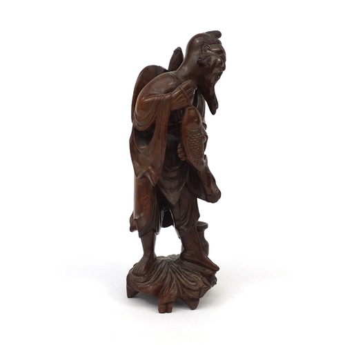 543 - Chinese hardwood root carving of a fisherman holding a fish, 30cm high