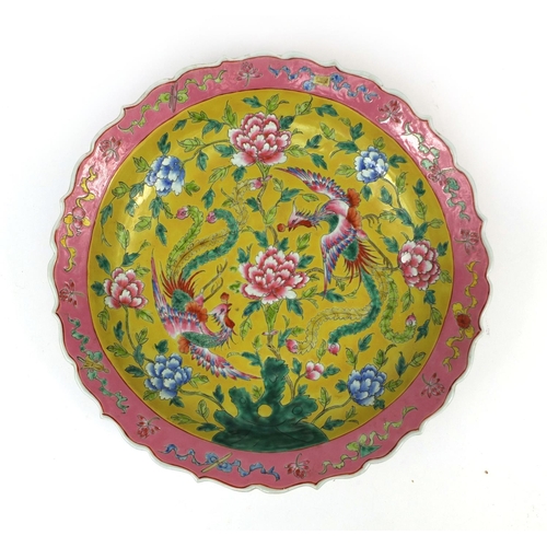 479 - Chinese porcelain charger, hand painted in the famille rose palette onto a yellow ground, with phoen... 