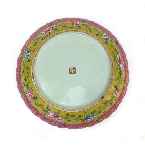 479 - Chinese porcelain charger, hand painted in the famille rose palette onto a yellow ground, with phoen... 