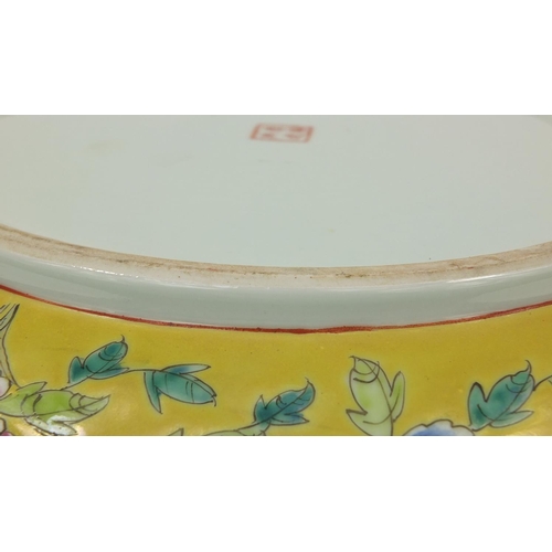 479 - Chinese porcelain charger, hand painted in the famille rose palette onto a yellow ground, with phoen... 
