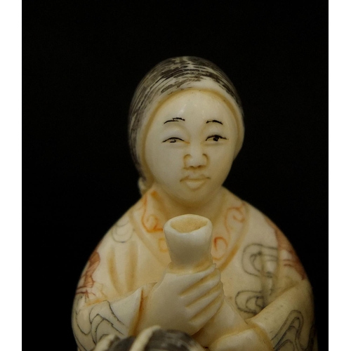 531 - Japanese carved ivory okimono of four figures drinking, character marks to the base, 6cm high