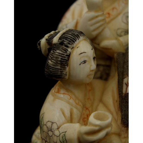 531 - Japanese carved ivory okimono of four figures drinking, character marks to the base, 6cm high