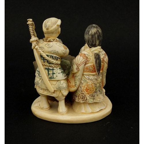 531 - Japanese carved ivory okimono of four figures drinking, character marks to the base, 6cm high