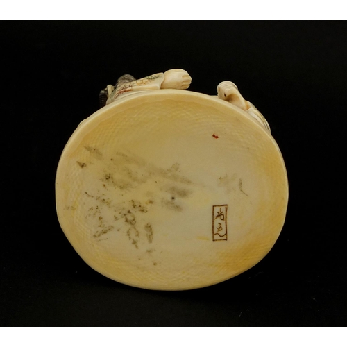 531 - Japanese carved ivory okimono of four figures drinking, character marks to the base, 6cm high