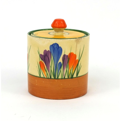 754 - Clarice Cliff crocus pattern cylindrical jam pot and cover, factory marks to the base, 9.5cm high