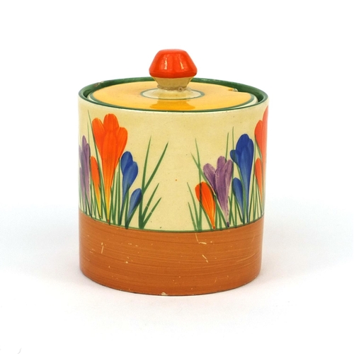 754 - Clarice Cliff crocus pattern cylindrical jam pot and cover, factory marks to the base, 9.5cm high