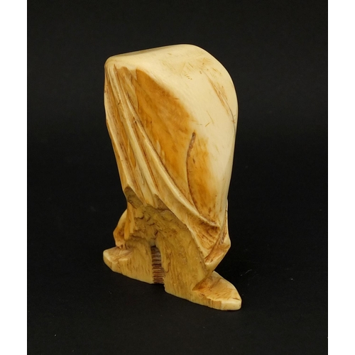 3 - Ivory carving of a Putti hiding behind a curtain, 7.2cm high
