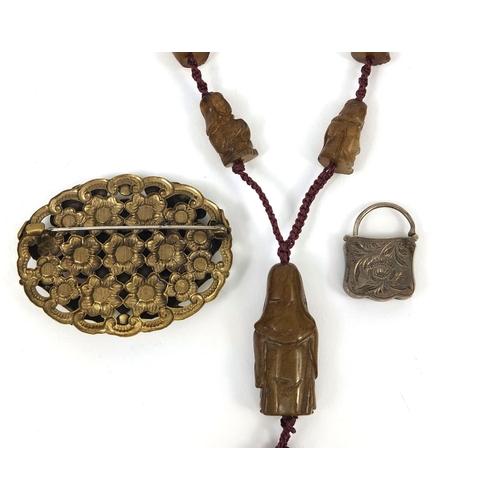 508 - Chinese jewellery comprising an enamelled brooch set with coral, silver padlock charm set with a gre... 