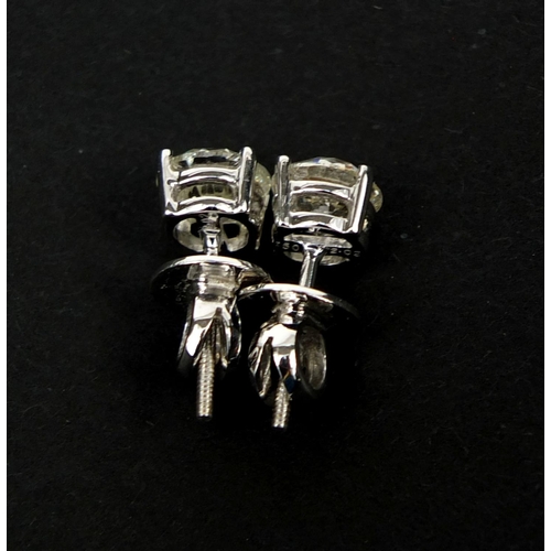 949 - Pair of 18ct white gold diamond solitaire earrings