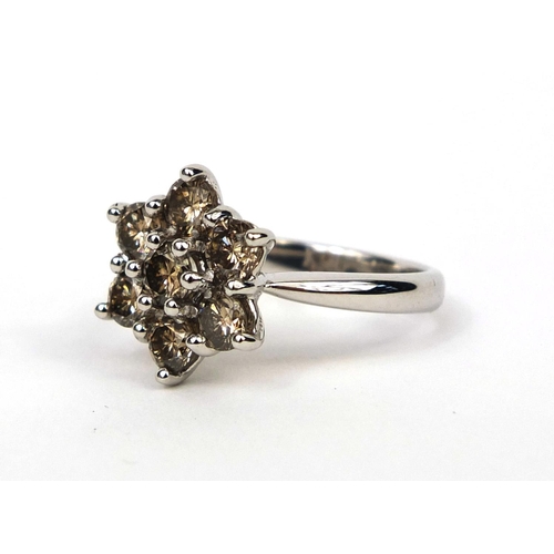 953 - 18ct white gold champagne diamond flower head ring, set with seven diamonds, size M, approximate wei... 