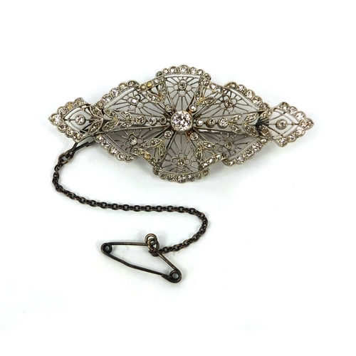 909 - Edwardian unmarked platinum fine lace work diamond brooch, 5.5cm long, approximate weight 10.0g with... 