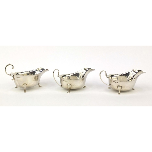 827 - Three silver three footed sauce boats including an Asprey example, the larger 15.5cm long, approxima... 