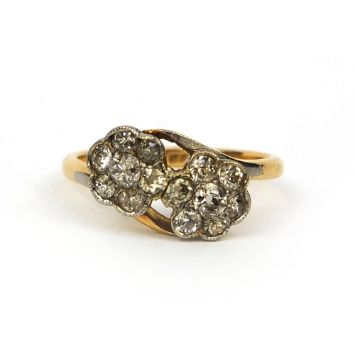 1001 - 18ct gold diamond double flower head crossover ring, set with fourteen diamonds, size L, approximate... 