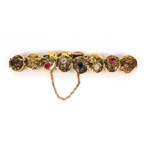 916 - Designer unmarked gold bracelet set with diamonds, ruby's and a sapphire, 18cm long, approximate wei... 