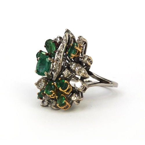 921 - Unmarked white metal emerald and diamond cocktail ring, set with ten emeralds and twenty four diamon... 