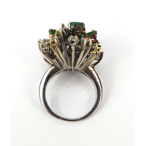 921 - Unmarked white metal emerald and diamond cocktail ring, set with ten emeralds and twenty four diamon... 