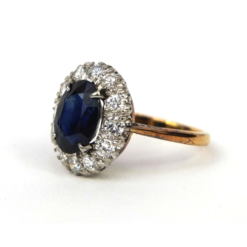 973 - Unmarked gold sapphire and diamond ring set with a central sapphire and twelve diamonds, size I, app... 