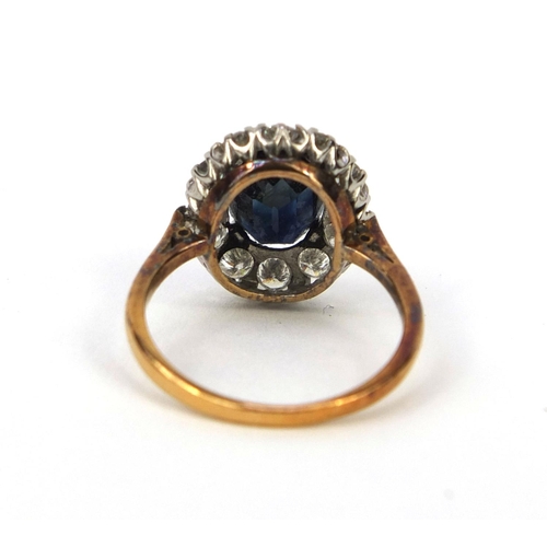 973 - Unmarked gold sapphire and diamond ring set with a central sapphire and twelve diamonds, size I, app... 