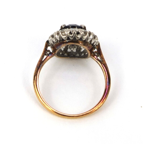 973 - Unmarked gold sapphire and diamond ring set with a central sapphire and twelve diamonds, size I, app... 