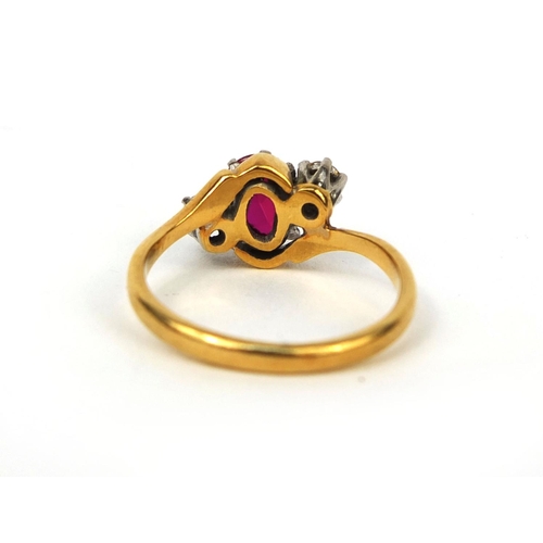 998 - 18ct gold ruby and diamond crossover ring set with a central ruby and two diamonds, size K, approxim... 