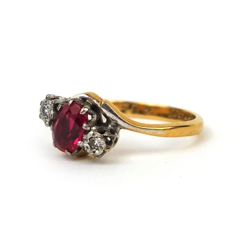 998 - 18ct gold ruby and diamond crossover ring set with a central ruby and two diamonds, size K, approxim... 