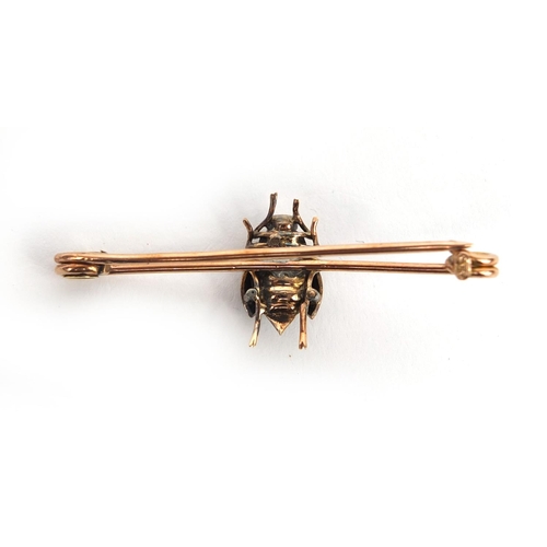 938 - 9ct gold insect bar brooch with a cabochon garnet body and diamonds to the wings, 5.2cm long, approx... 