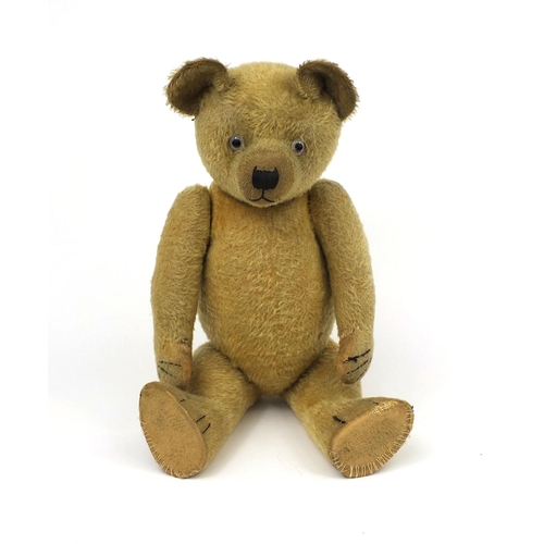 402 - Vintage straw filled teddy bear with  jointed limbs, growler and beaded glass eyes, 62cm in length