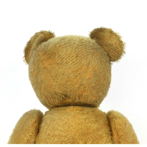 402 - Vintage straw filled teddy bear with  jointed limbs, growler and beaded glass eyes, 62cm in length