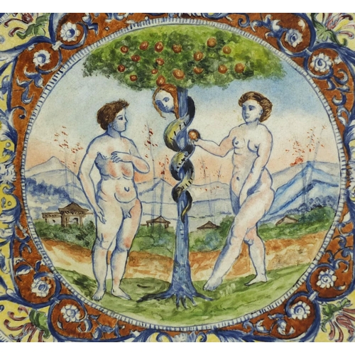 676 - Religious Dutch pottery plate hand painted with Adam and Eve taking the apple from the tree, inscrib... 