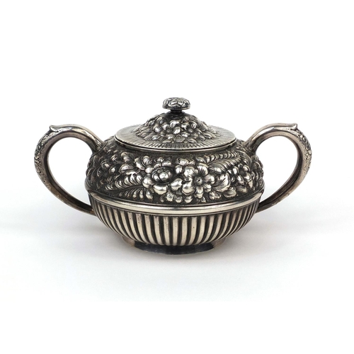 829 - American sterling silver twin handled sugar bowl and cover, profusely embossed with flowers and demi... 