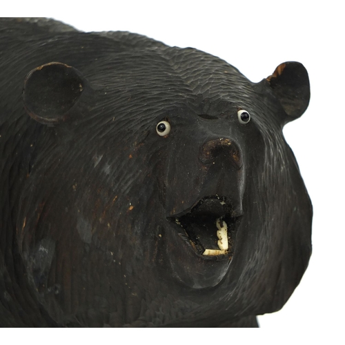 25 - Carved wooden bear with beaded eyes and bone teeth, 24.5cm in length