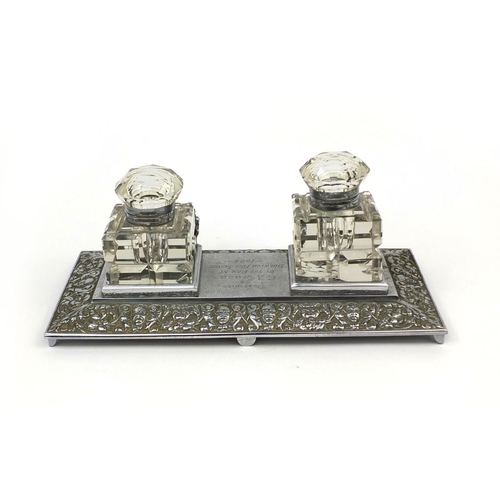 179 - Fire interest silver plated desk stand with two glass inkwells, presented to C R Couch by the men at... 