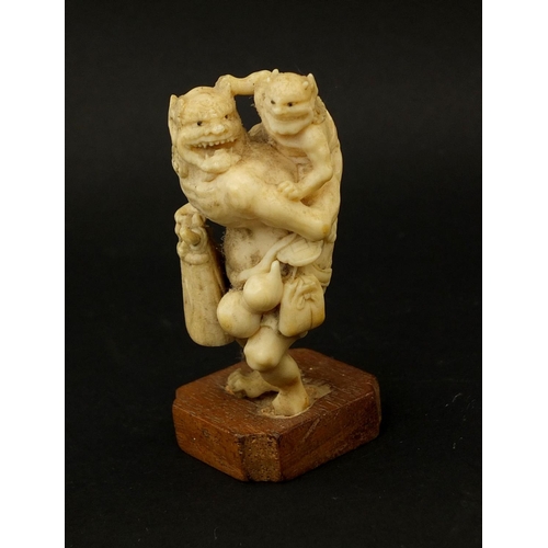 530 - Well detailed Japanese carved ivory okimono, two demons, one with a double gourd vessel, raised on a... 