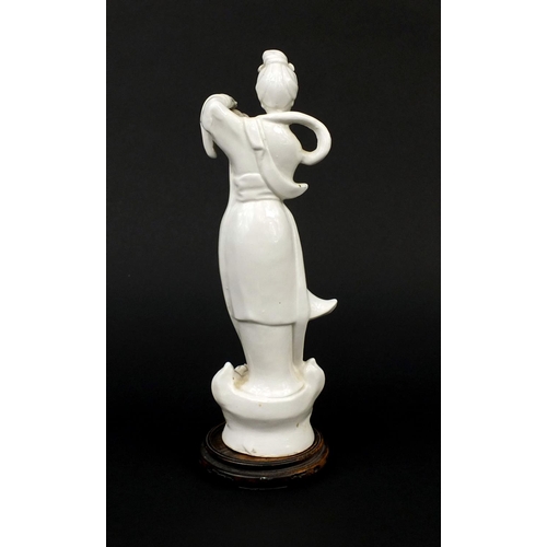 499 - Chinese porcelain Blanc De Chine figure of Guayin, raised on a pierced hardwood base, red seal mark ... 