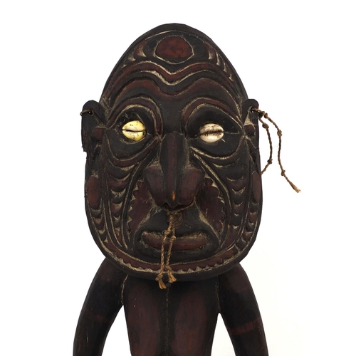 650 - Sepik River wood figural carving, Papa New Guinea, with cowrie shell eyes, 61cm high