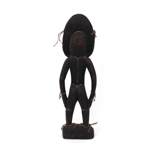 650 - Sepik River wood figural carving, Papa New Guinea, with cowrie shell eyes, 61cm high