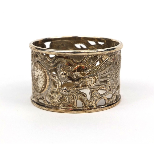 537 - Chinese silver napkin ring decorated with a dragon chasing the flaming pearl, impressed MN and chara... 