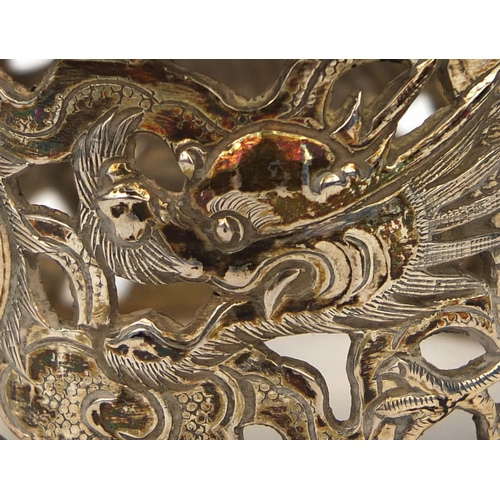 537 - Chinese silver napkin ring decorated with a dragon chasing the flaming pearl, impressed MN and chara... 