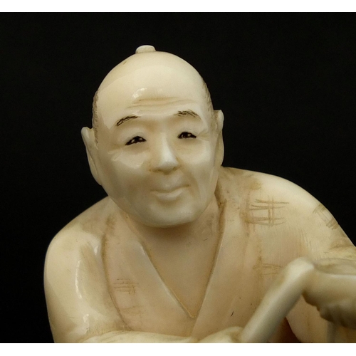 532 - Japanese carved ivory okimono of a seated man, 5.3cm high