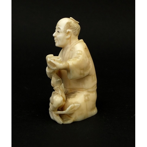 532 - Japanese carved ivory okimono of a seated man, 5.3cm high