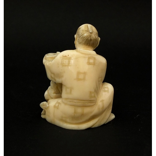 532 - Japanese carved ivory okimono of a seated man, 5.3cm high