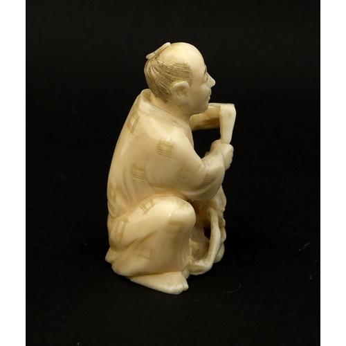 532 - Japanese carved ivory okimono of a seated man, 5.3cm high