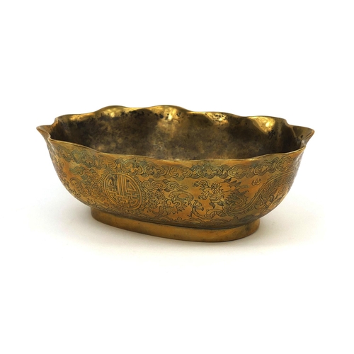 558 - Chinese bronze bowl with shaped edge, engraved with dragons chasing the flaming pearl, character mar... 