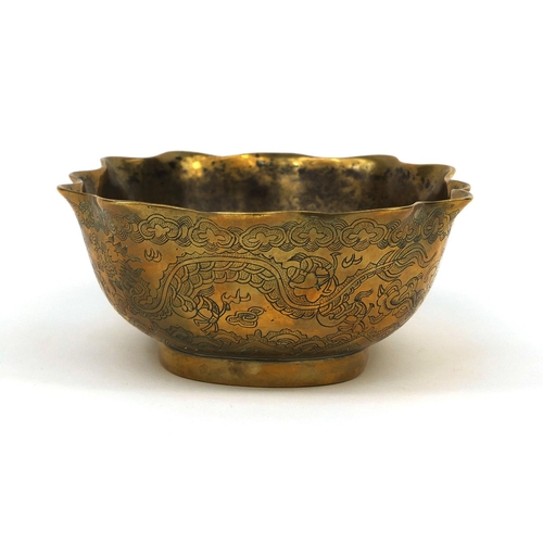 558 - Chinese bronze bowl with shaped edge, engraved with dragons chasing the flaming pearl, character mar... 