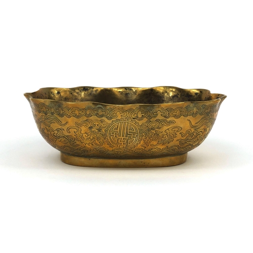 558 - Chinese bronze bowl with shaped edge, engraved with dragons chasing the flaming pearl, character mar... 